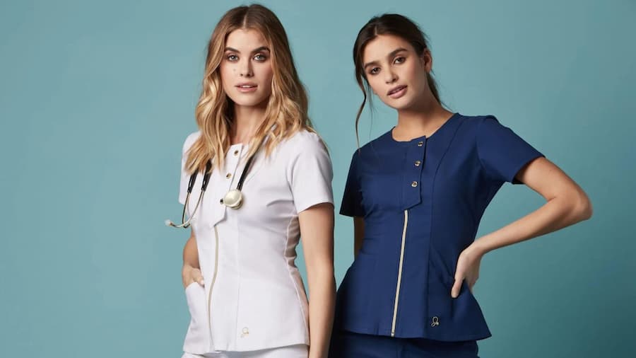 Two beautiful female doctors wearing doctor scrubs and standing in style